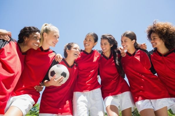 sports team smiles and stands together